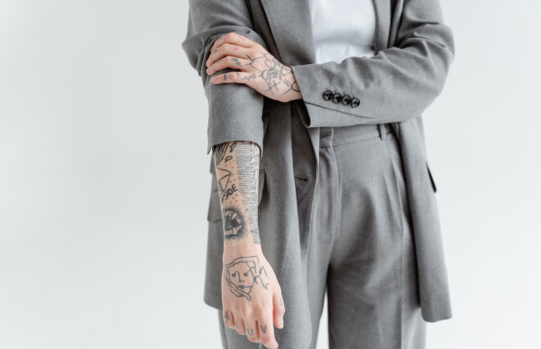 Person in a suit with tattoos